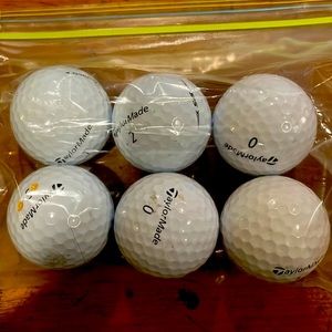 Six used TaylorMade golf balls tp5